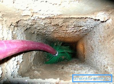 Cleaning the ventilation in an apartment building with a brush Cleaning the ventilation in an apartment building with a brush