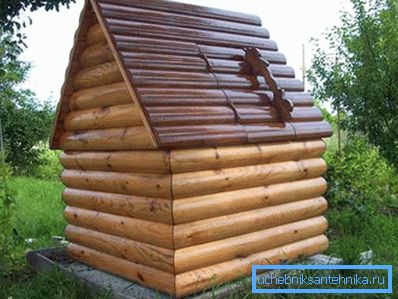 The house and the well inside. The combination of metal (roof of corrugated board) and wood (walls of rounded logs) The house and the well inside. The combination of metal (roof of corrugated board) and wood (walls of rounded logs)