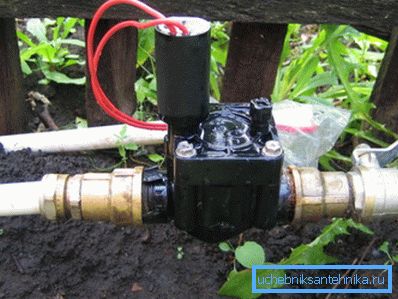 Electric crane on the street in the country to automate watering the garden Electric crane on the street in the country to automate watering the garden