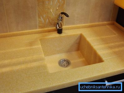 Photo of a stone sink integrated into the tabletop. Photo of a stone sink integrated into the tabletop.