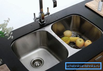 The integrated sink from a stainless steel in a table-top from an artificial stone. The integrated sink from a stainless steel in a table-top from an artificial stone.