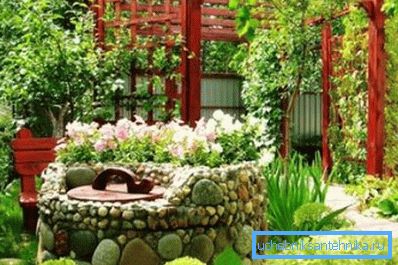 Well, decorated with stones and flowers Well, decorated with stones and flowers