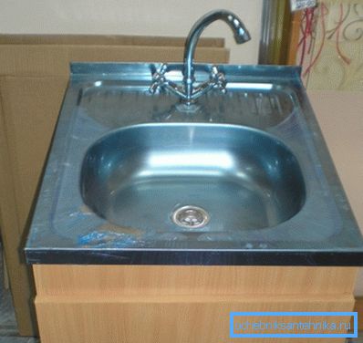 Sink from a stainless steel with a curbstone and the mixer Sink from a stainless steel with a curbstone and the mixer