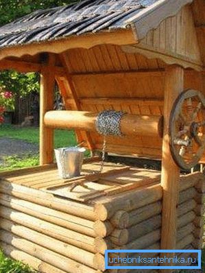 In the photo - a well with a hatch under a canopy