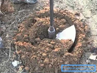 In the photo - drilling a well for water in a suburban area with a homemade tool