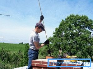 In the photo - cleaning the chimney with a ruff In the photo - cleaning the chimney with a ruff
