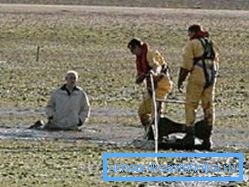 The photo shows the rescuers who arrived to the aid of a man who was stuck in the quicksand.
