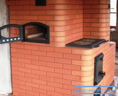 The photo heating-cooking stove made of brick on the wood.