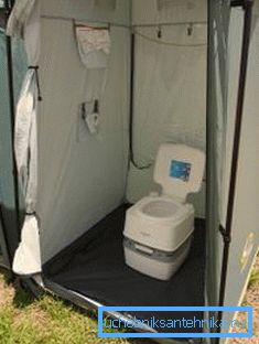 On a photo - a portable dry closet with a tent On a photo - a portable dry closet with a tent