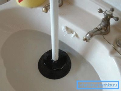On the photo - preparation for pipe cleaning with a plunger On the photo - preparation for pipe cleaning with a plunger