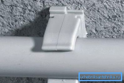 The photo shows a clip with a pipe. The photo shows a clip with a pipe.