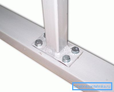 The photo shows the bolted connection of metal pipes at an angle of 90 °. The photo shows the bolted connection of metal pipes at an angle of 90 °.