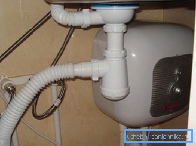 In the photo is an example of installation of a compact water heater. In the photo is an example of installation of a compact water heater.