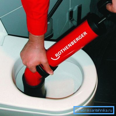On the photo - cleaning the toilet with pneumatic