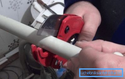 On a photo - cutting of a polypropylene pipe with special scissors. On a photo - cutting of a polypropylene pipe with special scissors.