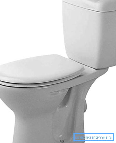 On the photo - a toilet with a cistern on the shelf On the photo - a toilet with a cistern on the shelf
