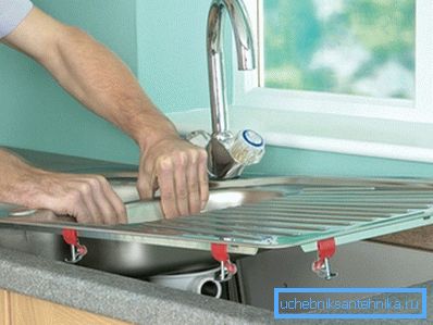 In the photo - the installation of a rectangular sink in the countertop