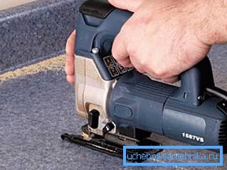 On the photo - cutting a hole with a jigsaw On the photo - cutting a hole with a jigsaw