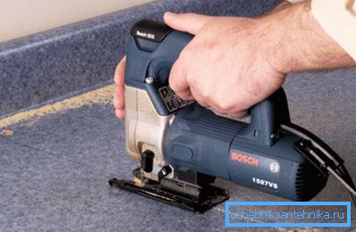 An electric jigsaw saw is inserted into a hole prepared in the corner. An electric jigsaw saw is inserted into a hole prepared in the corner.