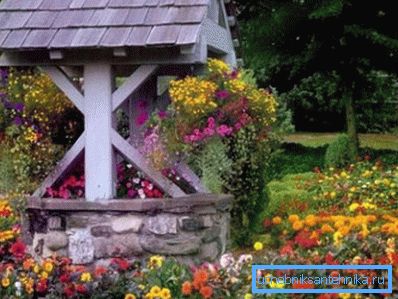 A solid stone base, massive wooden parts and a shingled roof - this well decoration gives the object a medieval charm A solid stone base, massive wooden parts and a shingled roof - this well decoration gives the object a medieval charm