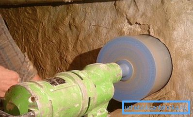 The process of punching holes for the water supply to the house under the foundation.