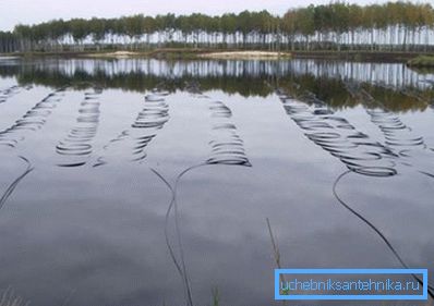 Laying the heat exchanger on the bottom of the pond.