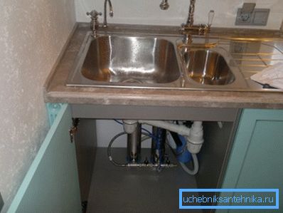 Installation of household filter in the nightstand under the sink. Installation of household filter in the nightstand under the sink.