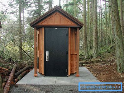 Insulated toilet on a concrete base with a metal door Insulated toilet on a concrete base with a metal door