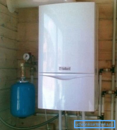 Appearance of a wall-mounted gas boiler with an expansion tank, which are connected to a single system Appearance of a wall-mounted gas boiler with an expansion tank, which are connected to a single system