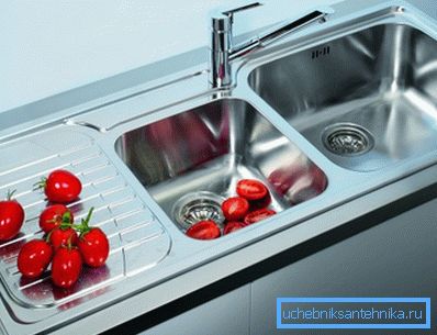 Mortise sink in the kitchen of stainless steel with two bowls and a wing Mortise sink in the kitchen of stainless steel with two bowls and a wing